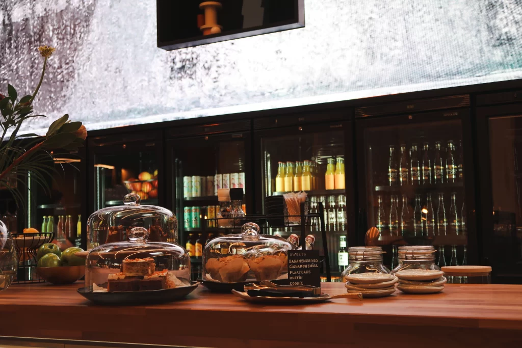 Gezellige baromgeving met een open keuken en houten accenten in een modern restaurant.